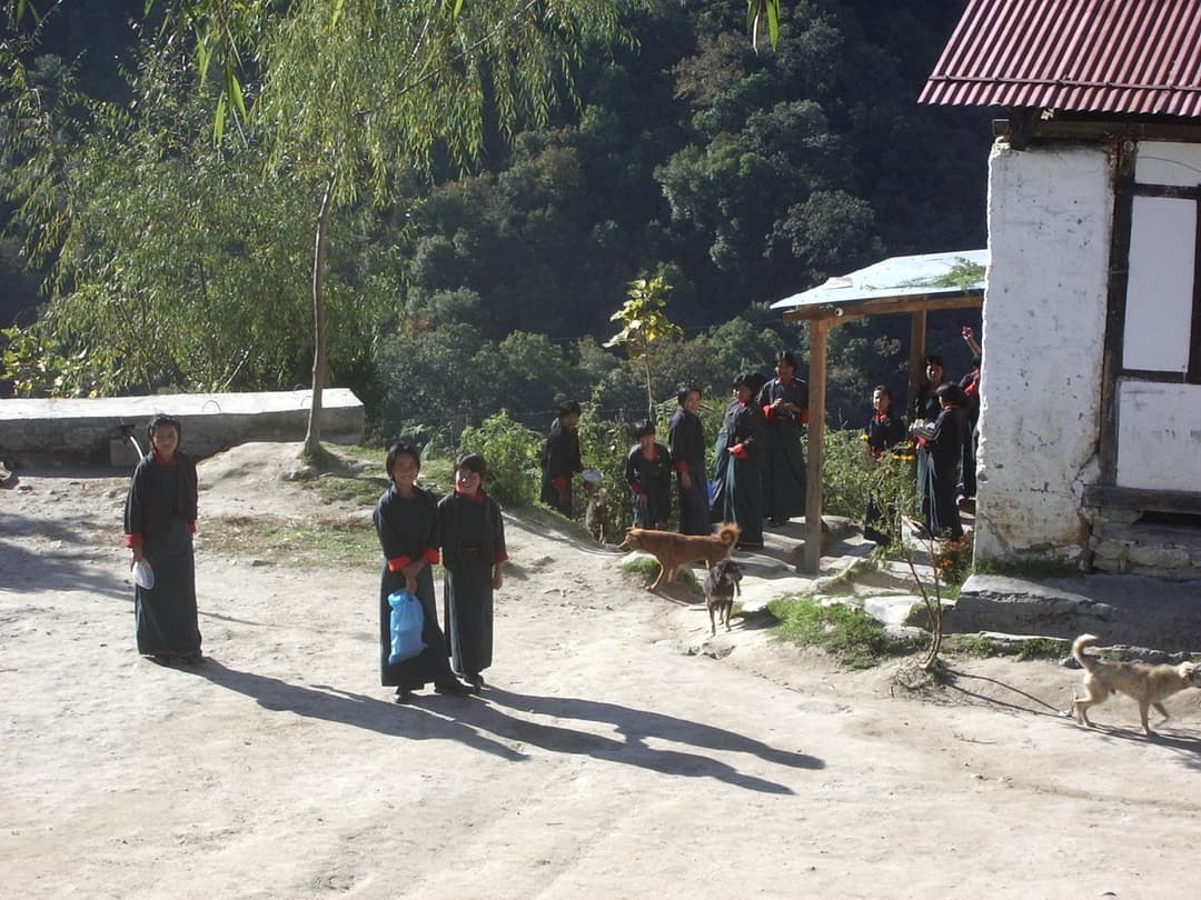 Children in traditional dress in the yard of a primary school in rural Bhutan