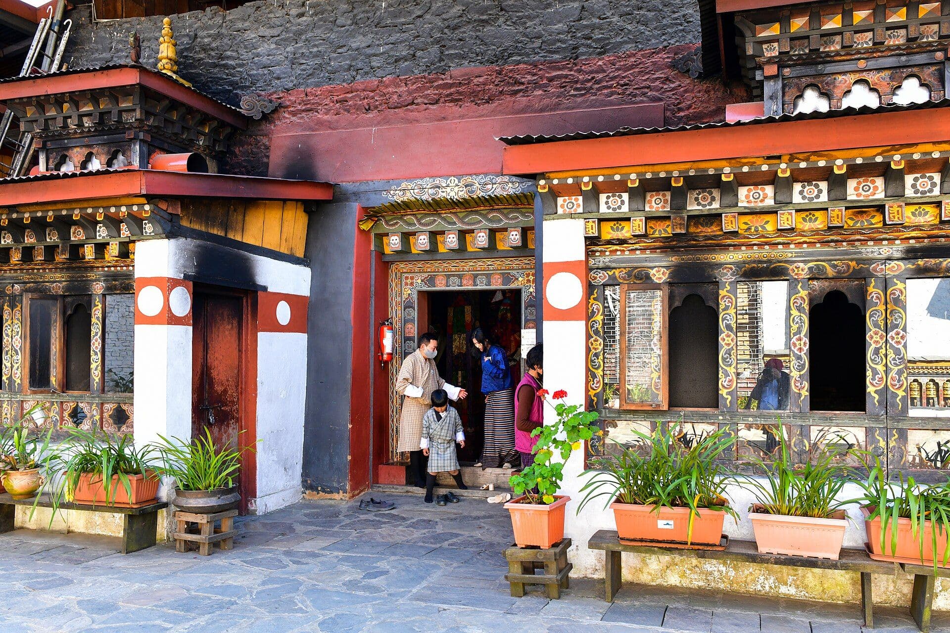 A family with a child at the door of Changangkha Lhakhang, Thimphu